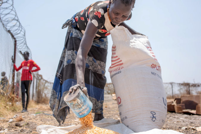 South Sudan Woman rations maize to ensure it can feed her entire household 